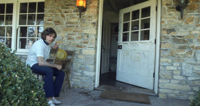 Roman Polanski on the front porch of 10050 Cielo Drive. Sharon Tate's blood was used write the word "PIG" on the front door.