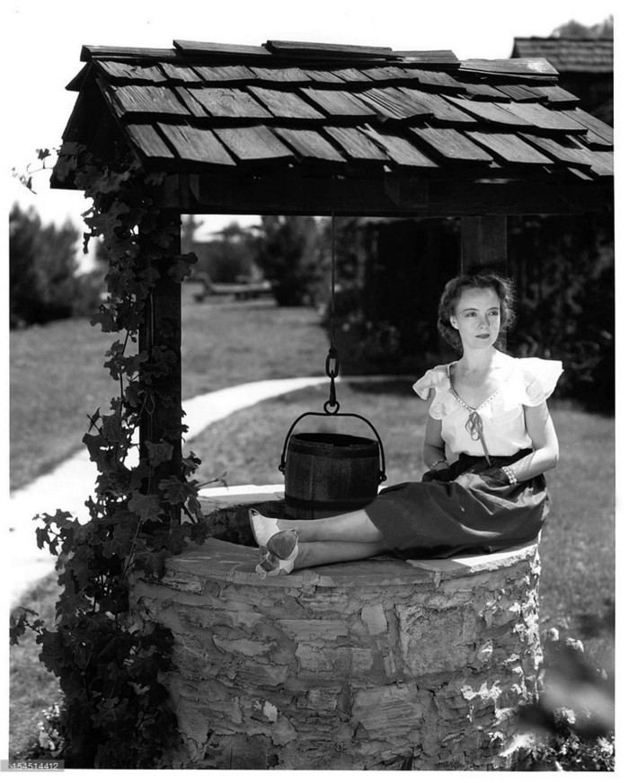 Lillian Gish sitting at the wishing well at 10050 Cielo Drive circa 1946.