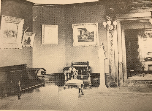 The art gallery/ballroom at Breeze Knoll in the 1920s. Note the mahogany entryway with the three pronged, globe capped sconces, picture and base molding. Oak paneling with a herringbone pattern covered the floors.